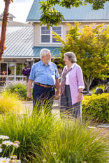 Senior couple holding hands in small downtown area